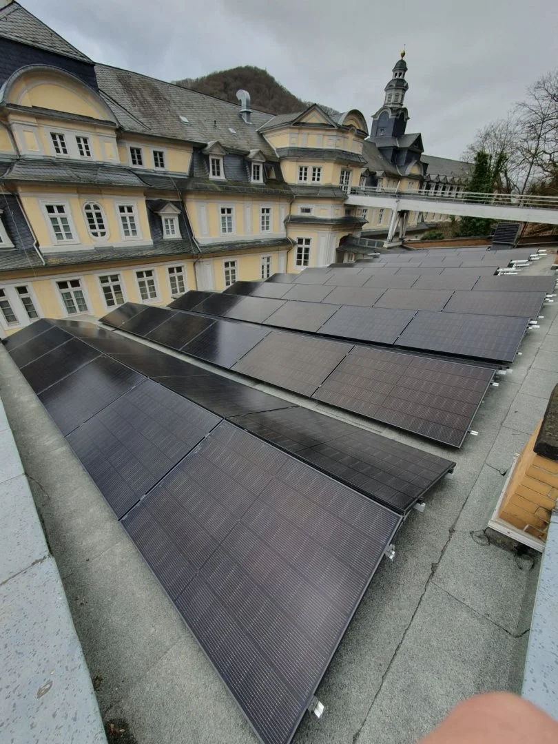 Solarmodule auf dem Dach eines historischen Gebäudes.